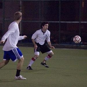 Players advance on the ball to the left