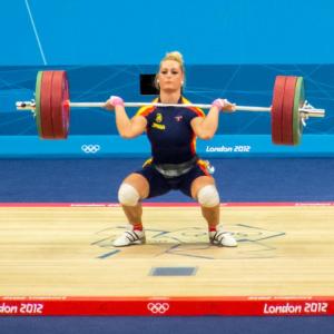 Woman doing Olympic weightlifting exercise.