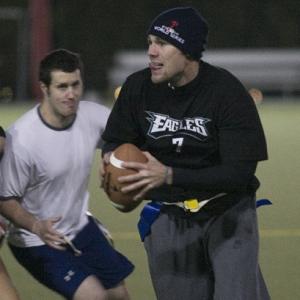two males playing flag football 