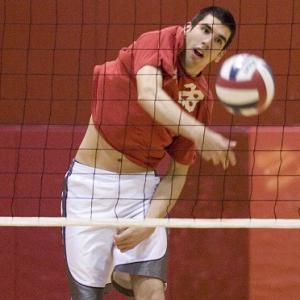 male hitting a volleyball 