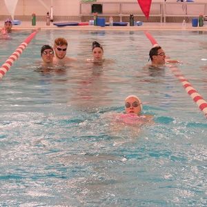 Students swim in a lane together