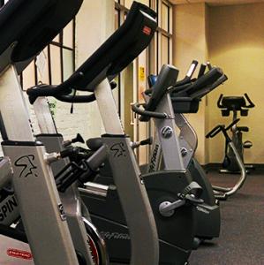 A row of exercise machines lined up against a wall