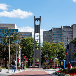 Bell Tower at Temple University with a student walking past