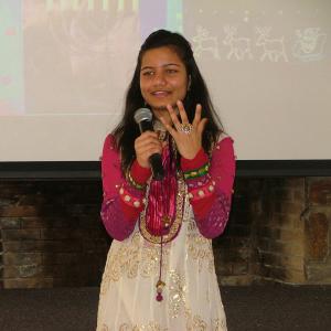 A student shares her cultural traditions during the Multicultural Holiday Celebration at Temple University Ambler.