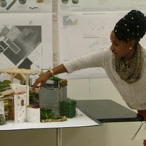 A student explains a scale model of Temple University Ambler 2016 Philadelphia Flower Show exhibit.