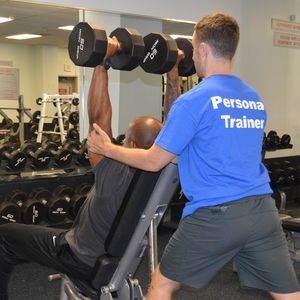 Personal Trainer Assisting Patron
