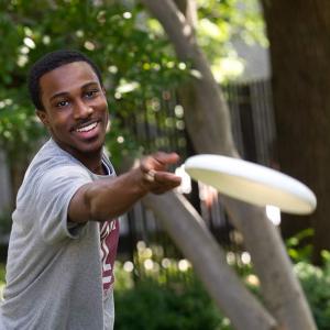 Temple student playing frisbee