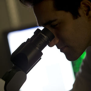 student looking in microscopr