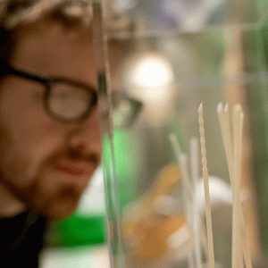 A man looking at 3D printed surgical needles