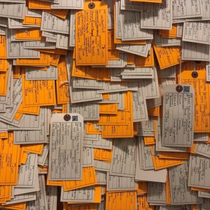 image of art installation, a collage of orange and tan tags