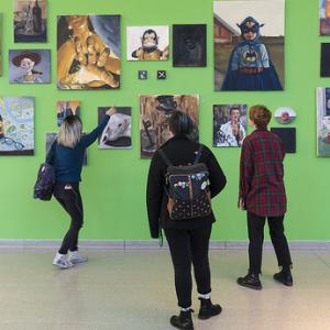 Students looking at a green hallway gallery