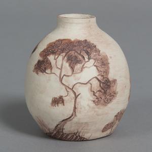 Hand-thrown ceramic pot with carved tree image; photo by Sam Fritch