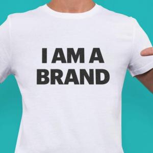 A man wearing a shirt that says "i am a brand"
