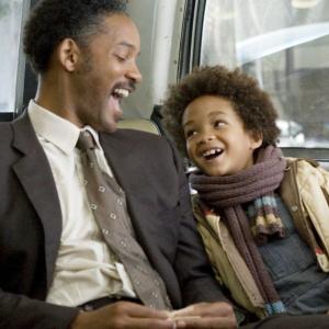 A picture of Will Smith and son Jaden sitting on a bus during a scene during the movie "The Pursuit of Happyness"