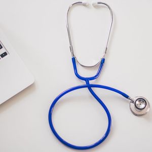 Photo of a stethoscope and laptop