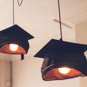 Lightbulbs wearing grad caps
