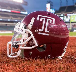 A cherry Temple football helmet with a white Temple “T.”