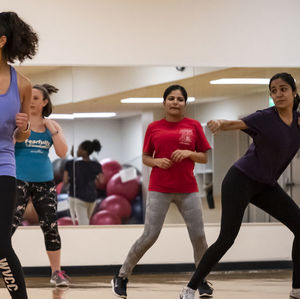 People in a zumba group fitness session 