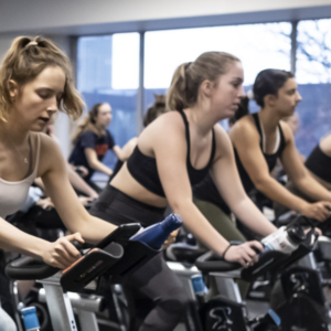 People riding their bikes in cycling class 