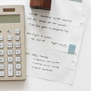 A grant application partially obscured by a calculator.