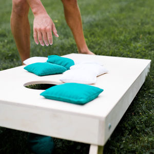 A picture of an intramural corn hole board with bean bags sitting on it.