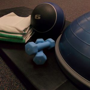 Workout equipment sitting on a foam pad.
