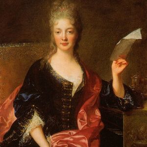 renaissance painting of a woman in a dark blue dress and pink shawl, holding a piece of paper