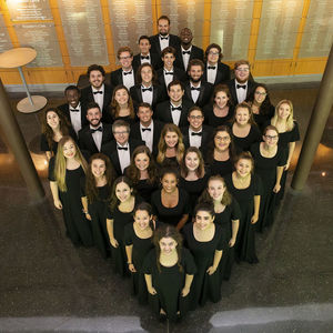 36 students, standing in a diamond formation looking up at the camera, wearing black formalwear