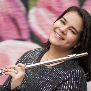 smiling woman with shoulder-length brown hair leaning her head back and holding a flute