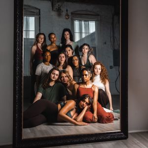 dancers posed together in front of mirror