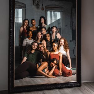dancers posed together in front of mirror