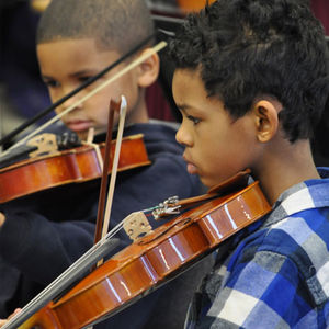 young students playing violins