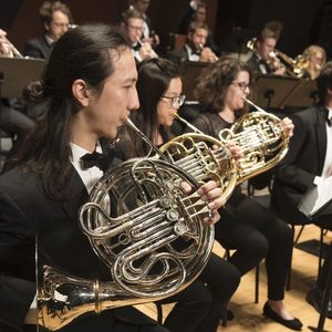 horn players in a band wearing black