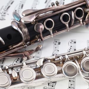flute and clarinet lying atop sheet music