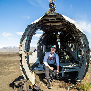 CARAS grantee sitting in a hollowed out plane, filming on location in Iceland