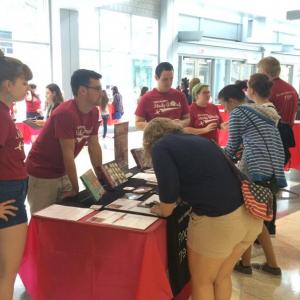 Students speak with Peer Advisors at an Info Table
